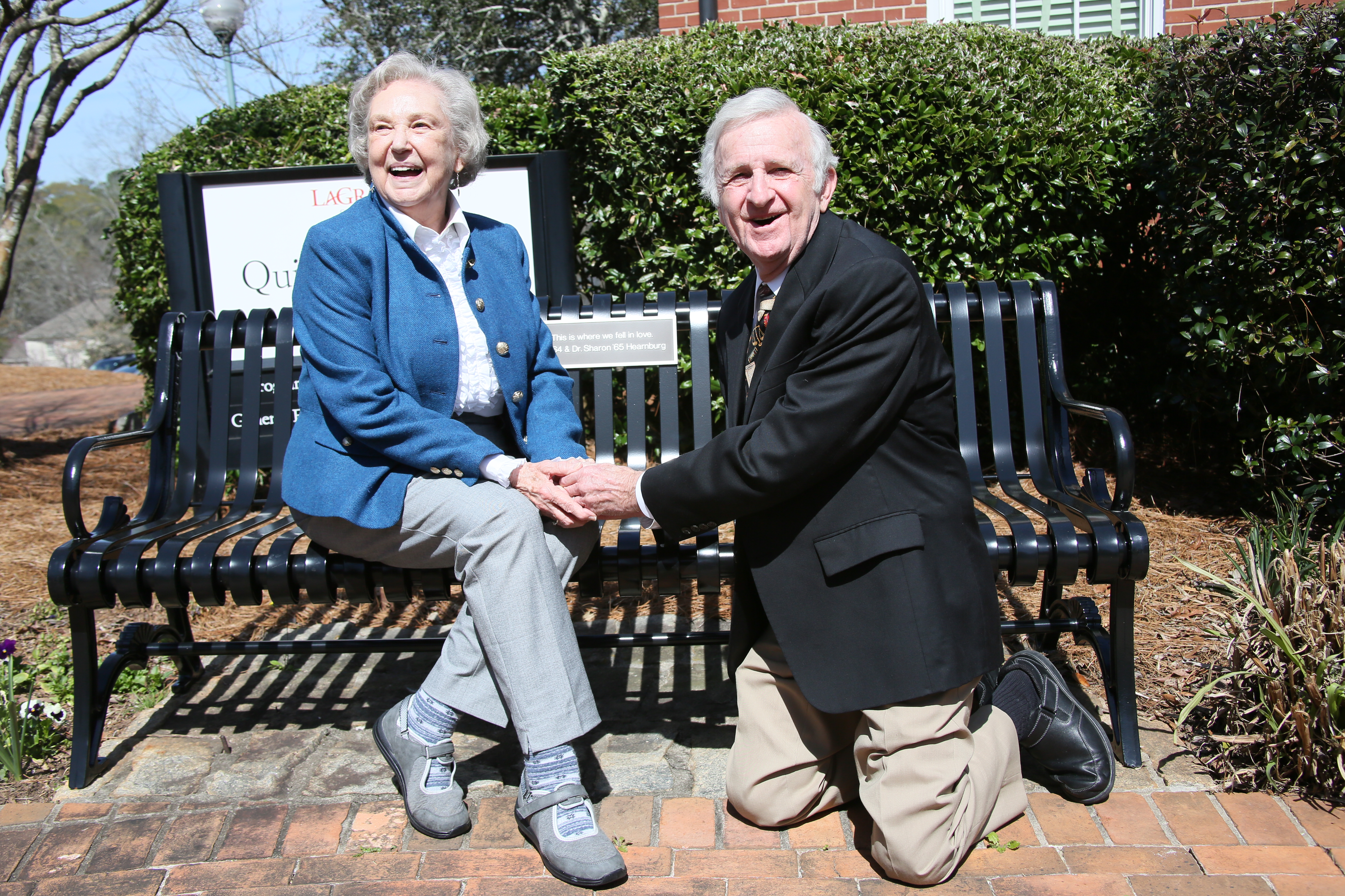 Bill '64 and Sharon '65 Hearnburg recreate their engagement in front of their bench outside the Quillian building. 