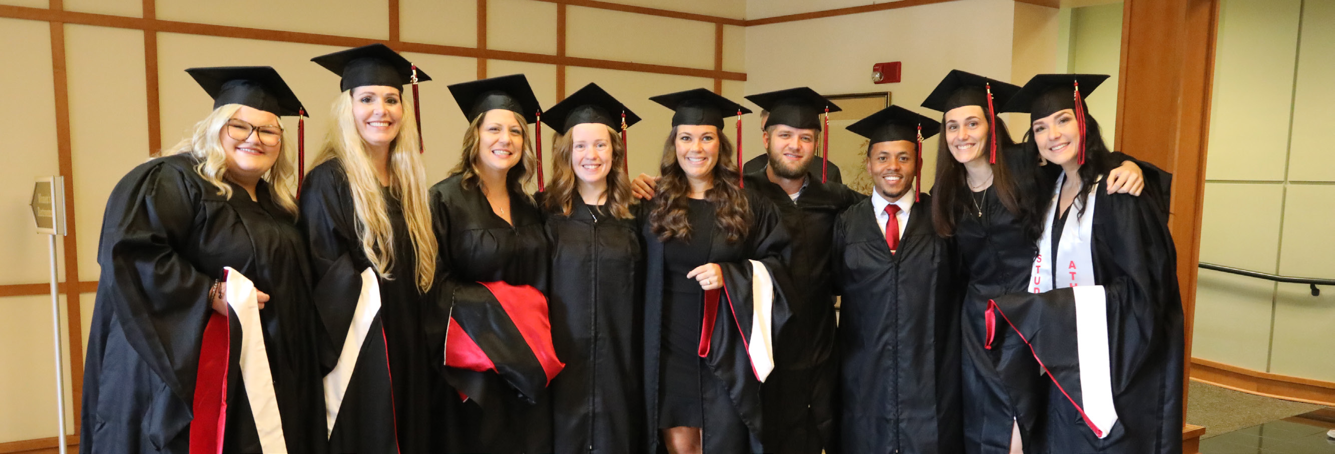 Graduates smile at the camera
