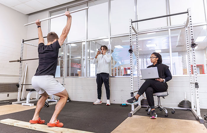 Two students practice in a gym
