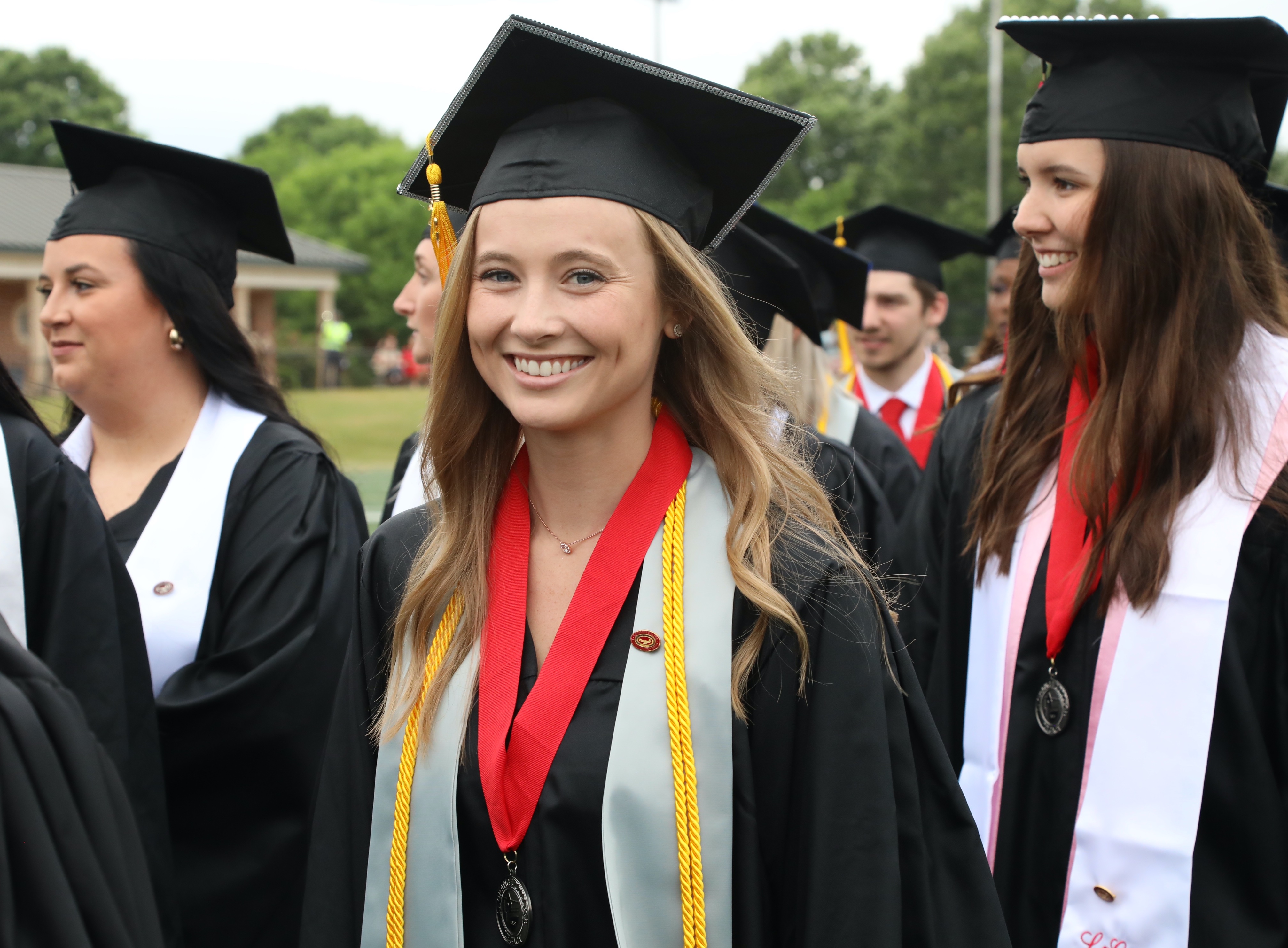 a female graduate smiles