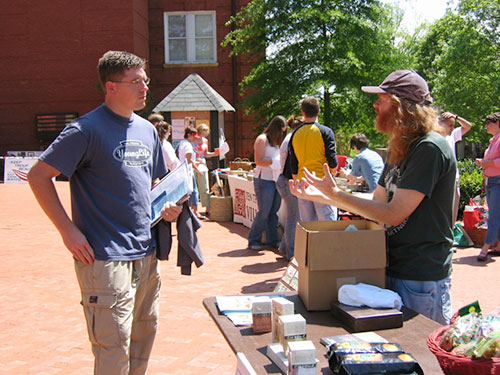 A student speaks with a vendor at the Sustainability Fair