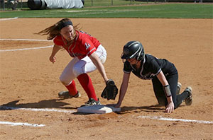 Softball player tags an opponent at the plate