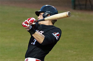 Baseball player swings big while at bat