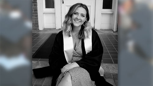 Senior Caitlyn Deal sits on the steps of historic Smith Hall