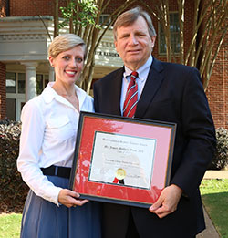 Jim Woods, right, and Laura Deen pose for a photo after Woods receives his alumni award