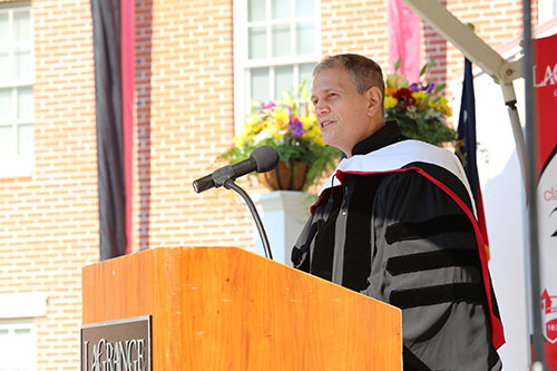 Police Chief Lou Dekmar stands at the podium on Commencement morning speaking to 2019 graduates