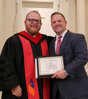 The Rev. Dr. Adam Roberts stands with Rev. Michael McCord as Roberts receives an award