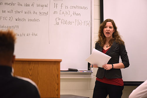 Stacey Erntsberger stands at the front of a classroom to teach