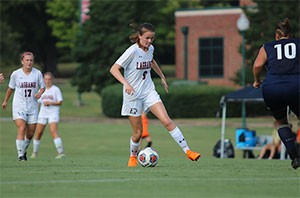 Women's soccer player with control of the ball