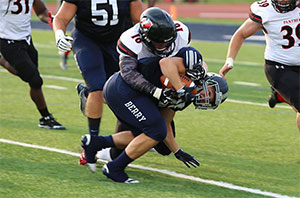 Football player tackles an opponent 