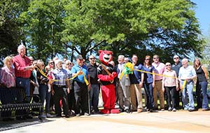 Pouncer cuts a ribbon at the Thread dedication