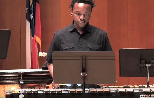 Student plays the marimba during a special holiday performance