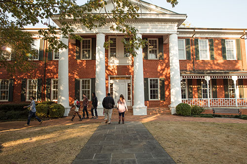 Smith Hall on a sunny day with students walking to and from the building