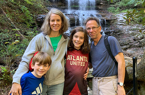 Dr. Baxter's family in front of a waterfall