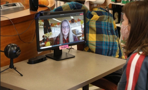 Librarian Amber Spratlin works with a student via computer