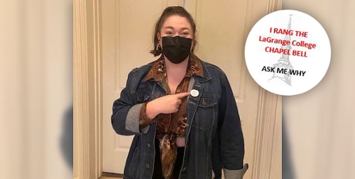 A student points to her "I Rang the Bell" sticker after successfully receiving acceptance into graduate school