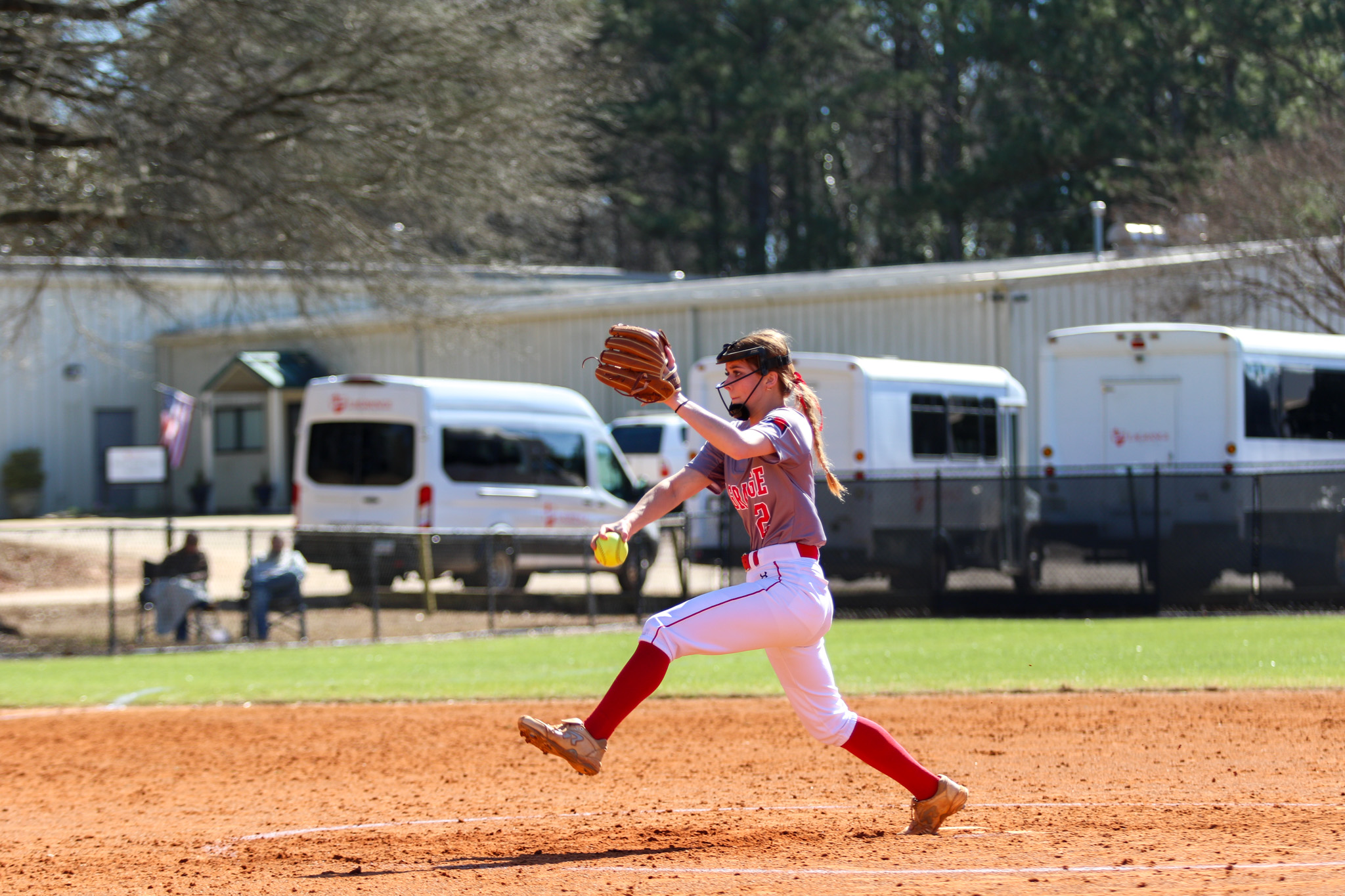 Student pitching on softball mound