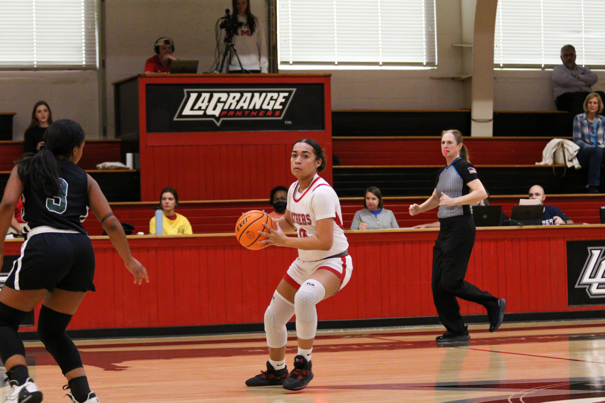 Student playing on basketball court