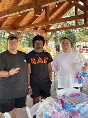 Fraternity members at community event