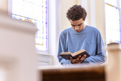 Student prays in Chapel
