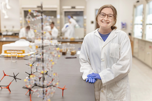 Student poses in lab