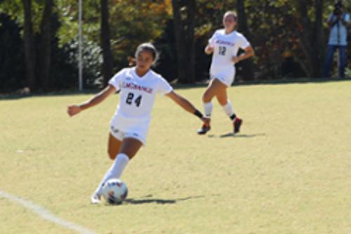 Women playing on soccer field
