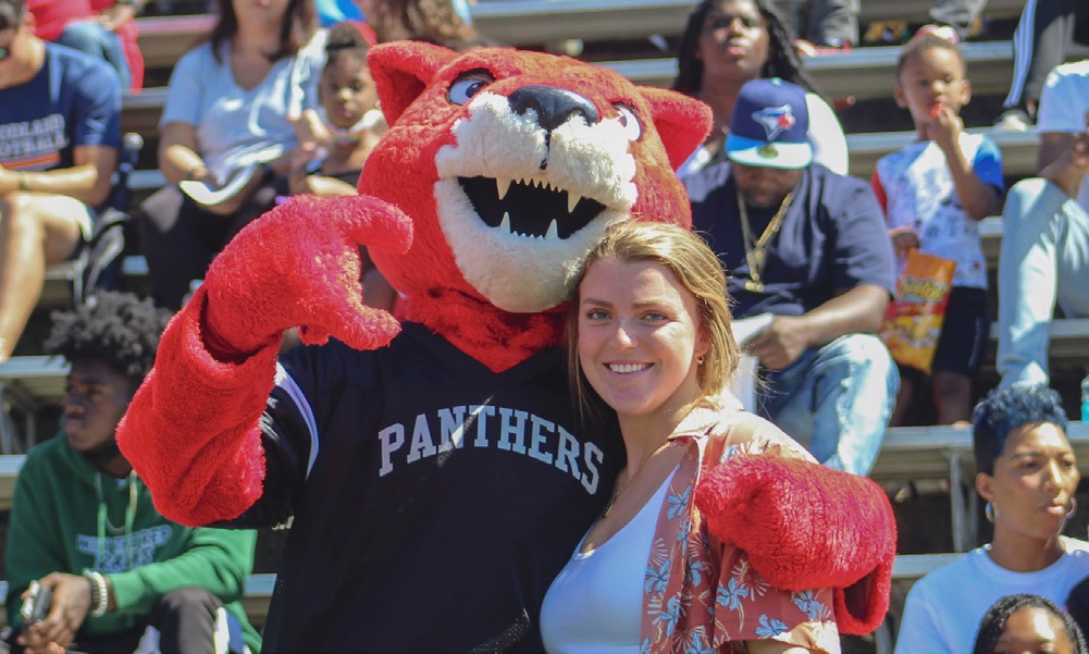 A female student poses with Pouncer