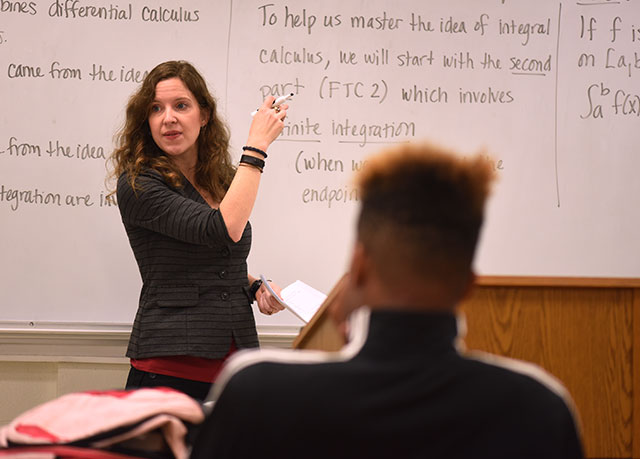 {Female professor at a white board}