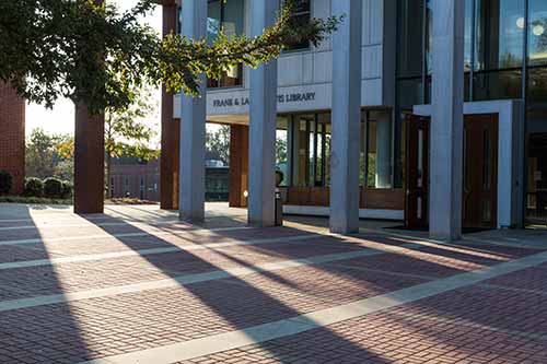 The front of the library drenched in light and shadows