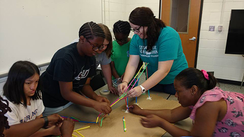 Students at the Learn 2 Serve camp work with a camp counselor