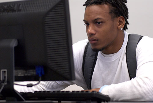 Male student working at a computer