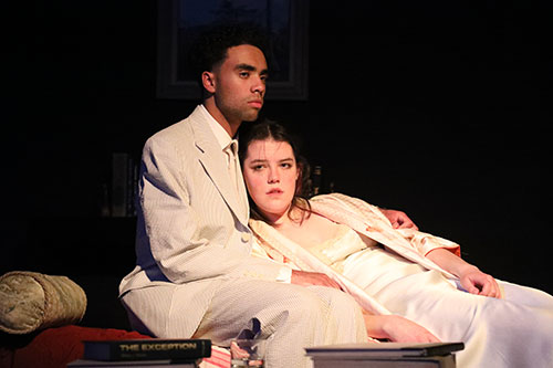 A couple look off stage during a performance