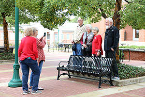 Class of 1973 poses with their bench