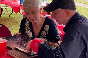 alumni reviewing yearbooks