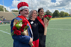 President Baxter celebrates the new Homecoming king and queen