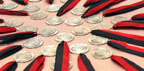 A table full of legacy medallions waits to be awarded to the legacy graduate