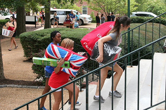 Students carrying their possessions into Hawkes Hall on move-in day