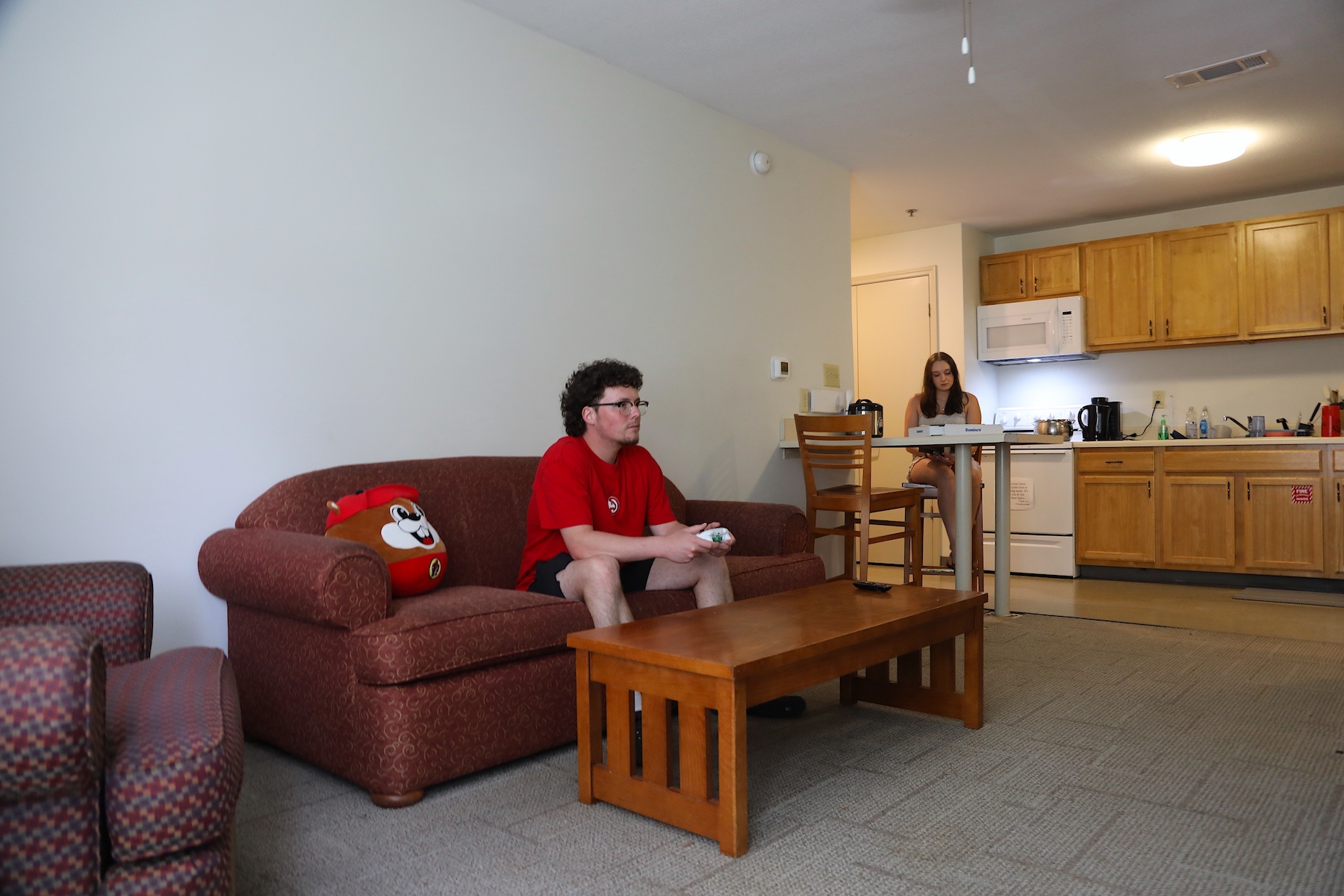 Interior view of living/dining space in Hawkins Hall with students