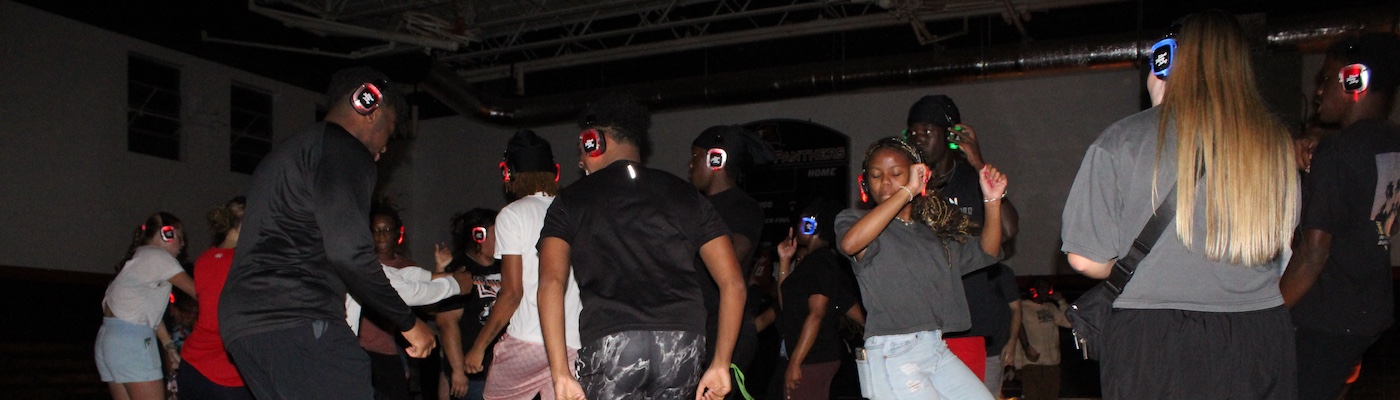 Students dancing during a silent disco event on campus.
