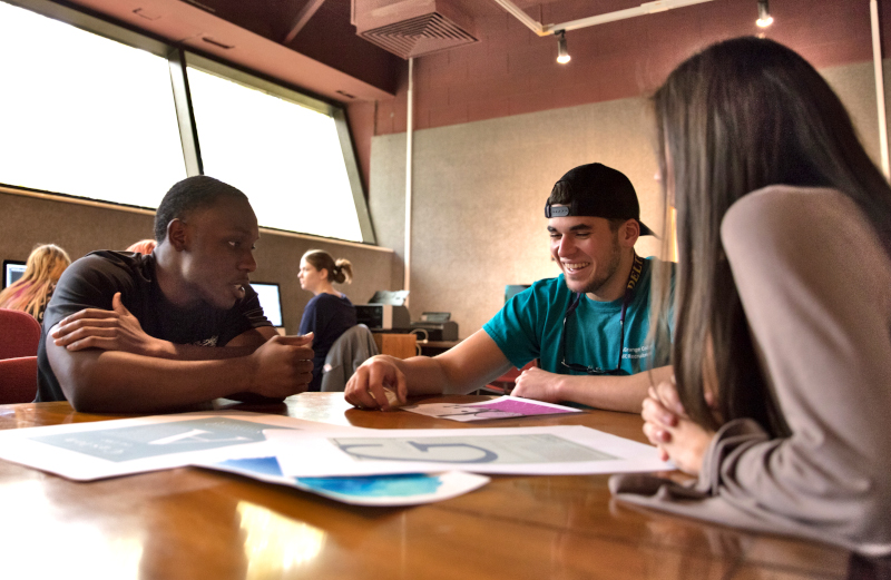 Three students in a classroom setting