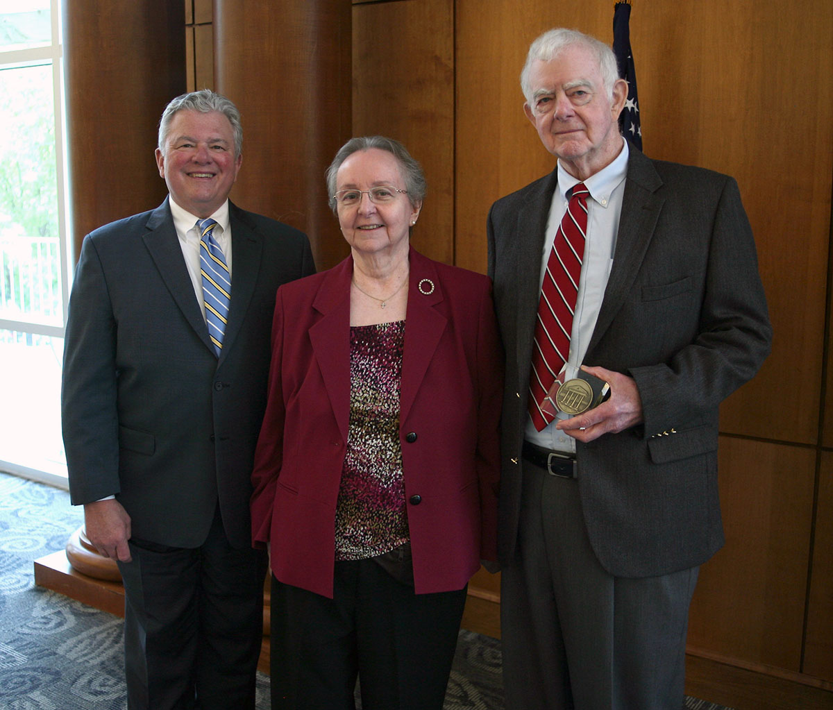 LC President Dan McAlexander, left, with Bruce and Emily Herrington.