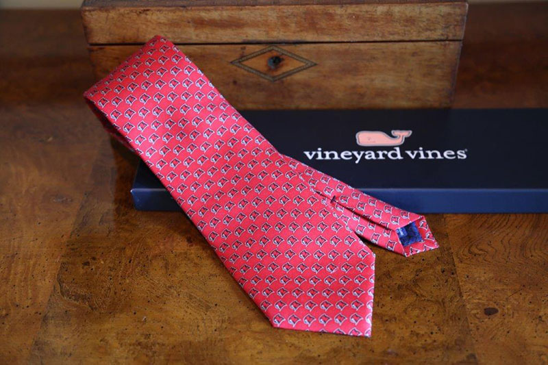Red panther club tie on a wooden table