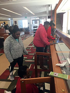 Students viewing a library exhibit