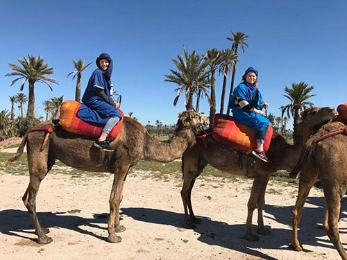 Jenna Brown riding a camel in Morocco