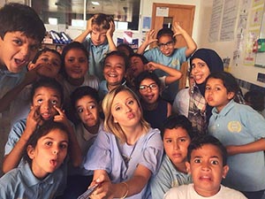 Jenna poses with a group of her students